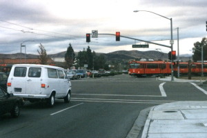 The San Diego Trolley crossing Mission Gorge Rd to enter the median on Cuyamuca Ave in Santee